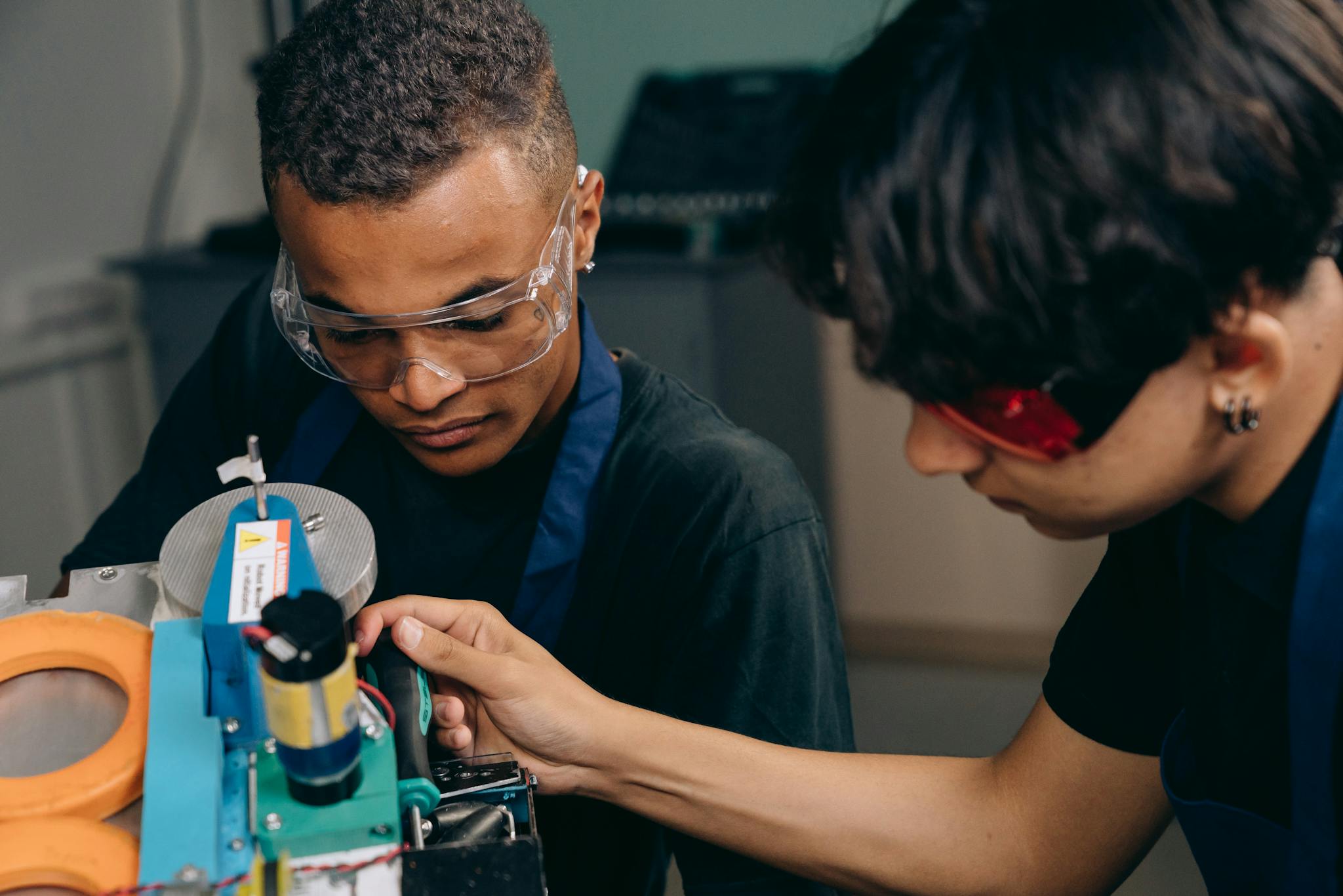 Home 7 Two engineers collaborate on machinery operation in an industrial setting.